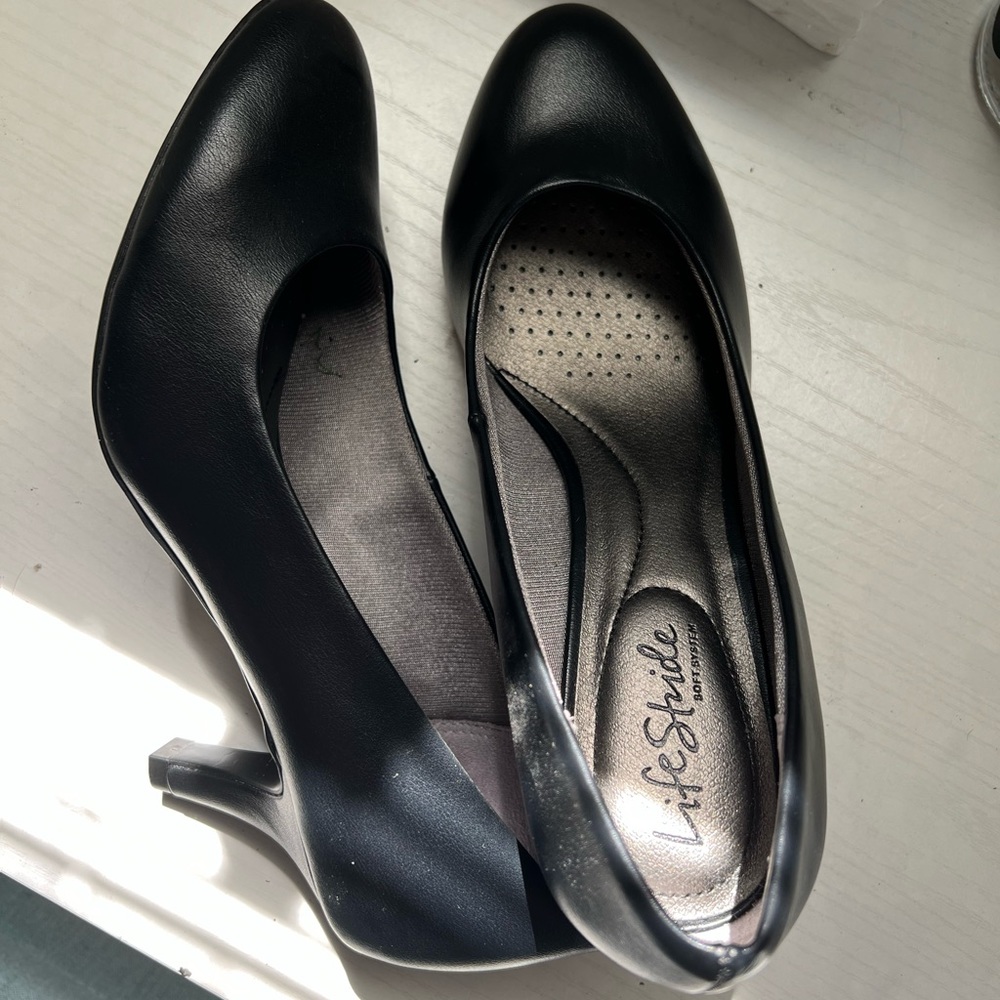 Women’s black slip on small heels.